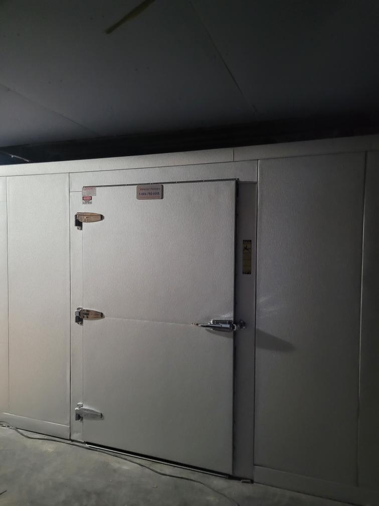 Walk-in mortuary cooler door and panel detail, heavy-duty hardware and insulated construction