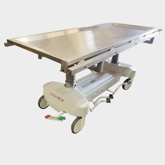 USPE-1038-2ATRT autopsy trolley side view, hydraulic mechanism, heavy-duty casters with locking brakes, integrated waste channel