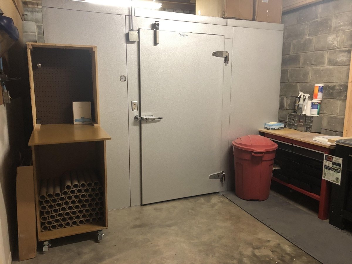 Close-up of mortuary cooler door with cam-lift hinges