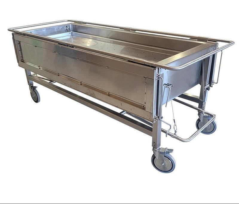 Modern stainless steel embalming table in funeral home preparation room