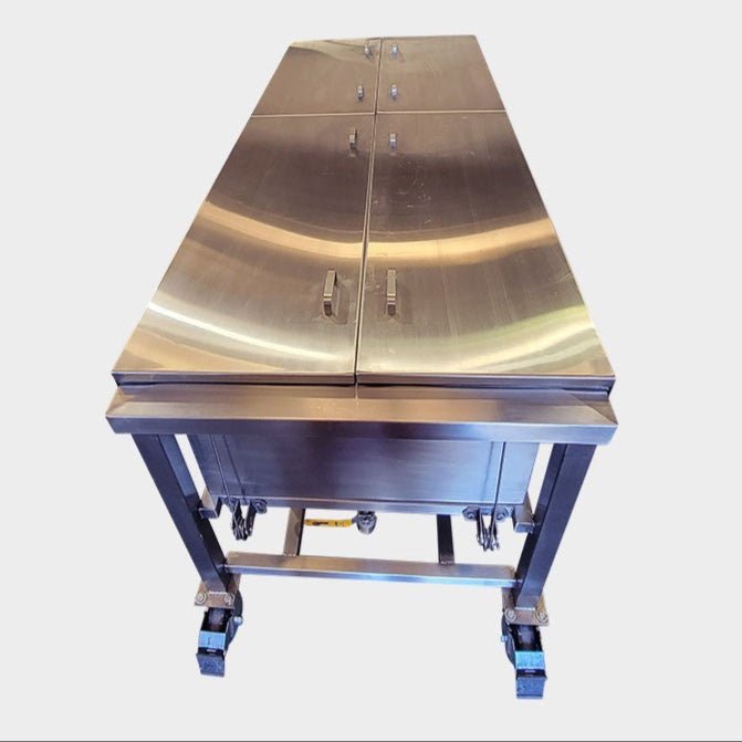 Stainless steel anatomy immersion tank with a counterbalanced lift system and perforated specimen tray, designed by American Mortuary Equipment Anatomy Division for professional anatomy lab equipment layouts.