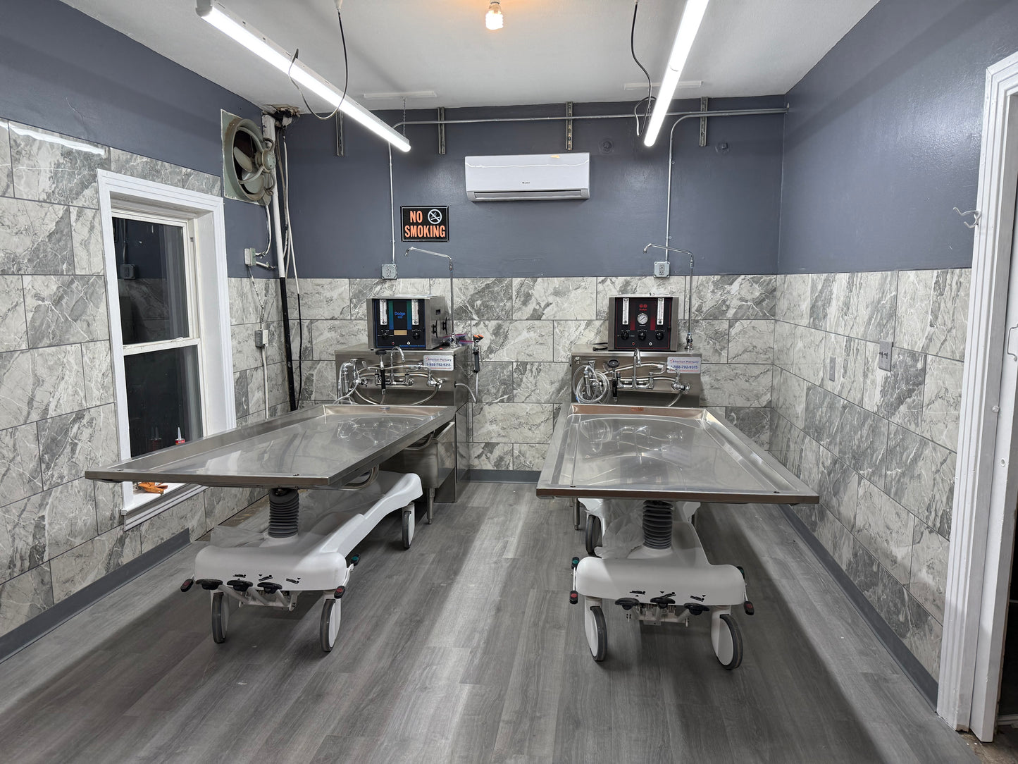 Bariatric 850 lb hydraulic embalming table in a mortuary preparation room, American Mortuary Equipment