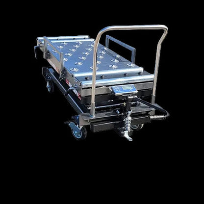 Funeral home scissor lift lowered to 20.5-inch loading height beside mortuary cooler