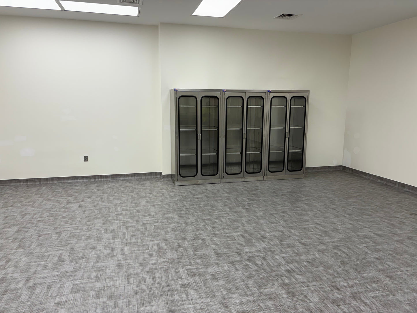 Tall wall cabinet with glass doors installed for university lab and morgue supply storage, Model 1034-3C
