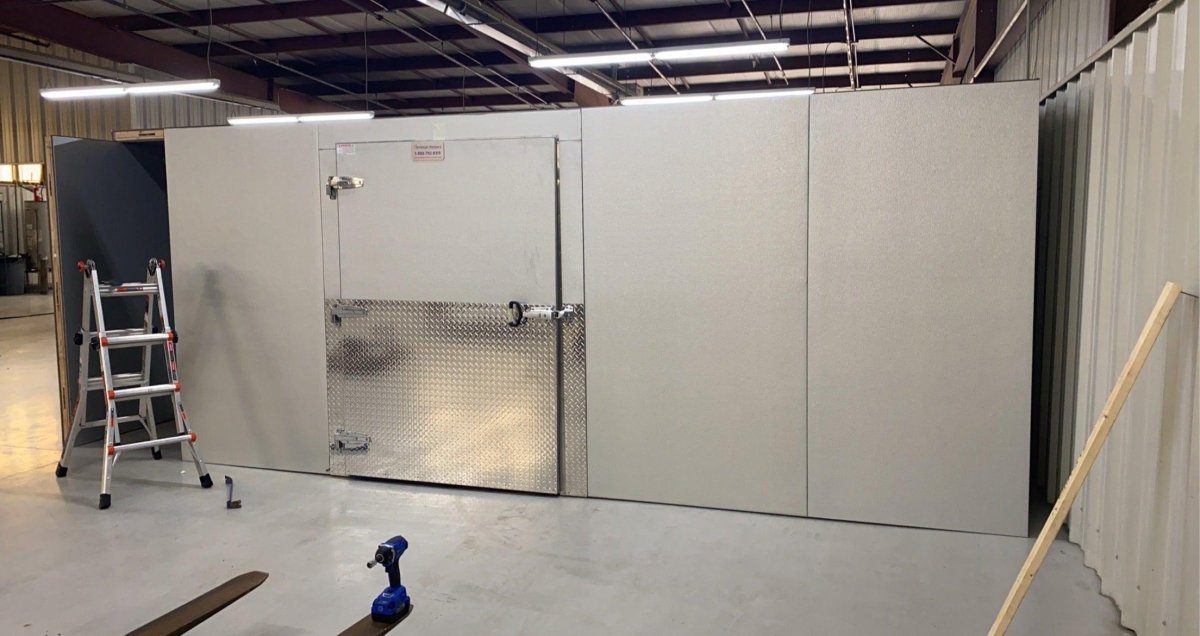 Heavy-duty self-closing door and hardware on an institutional walk-in mortuary refrigerator